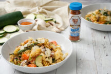 an image of Pasta Primavera next to a bottle of pork and veal magic seasoning